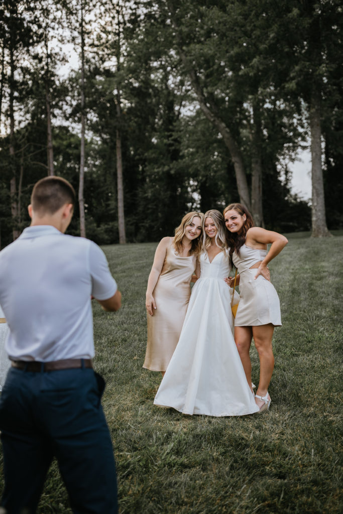 bride taking photos with guests