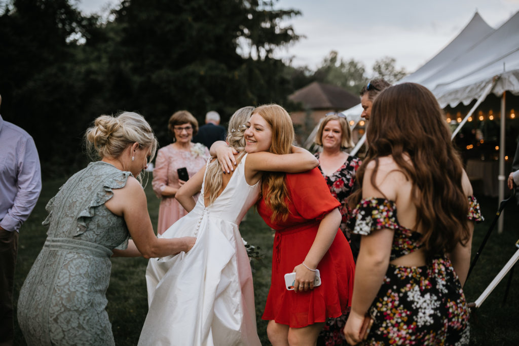 bride with guests and hugging 