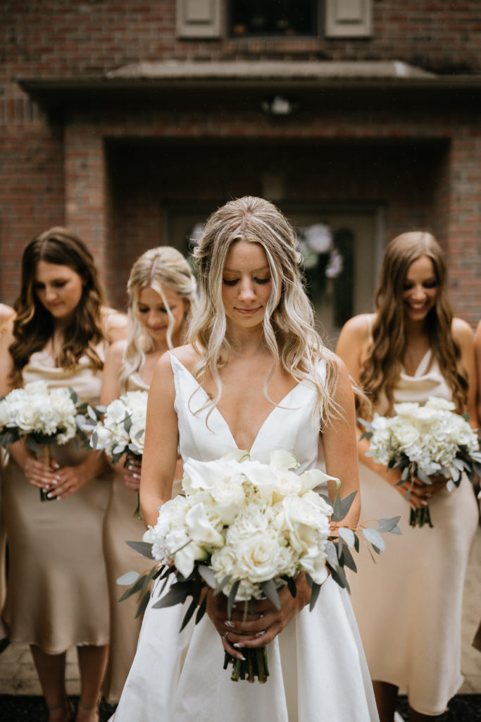 bride in focus with bridesmaids behind