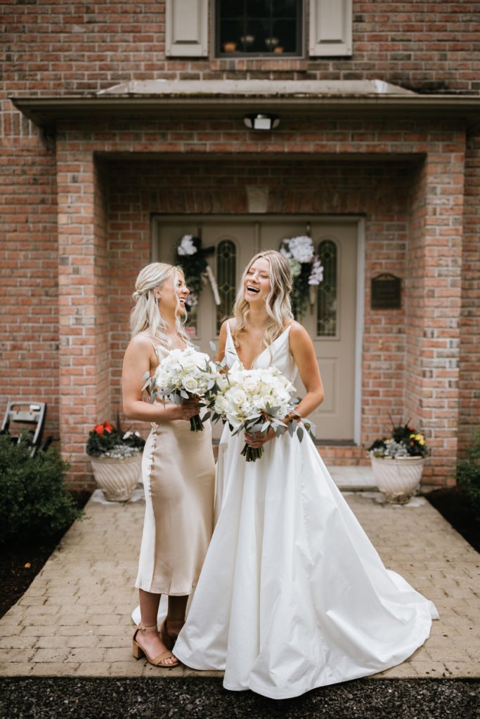 bride laughing with sister