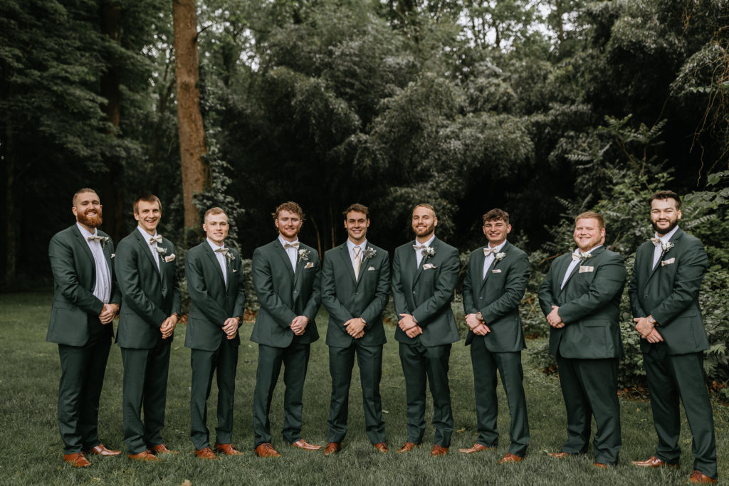 grooms and groomsmen standing in forest at Morgantown Wedding 
