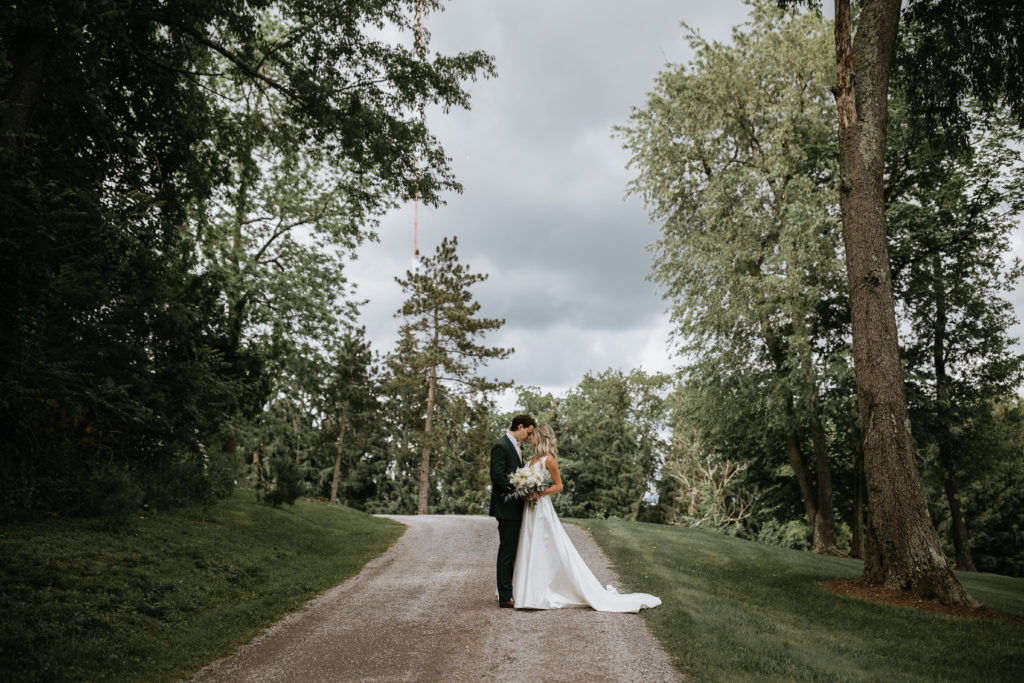 bride and groom portraits on gravel road