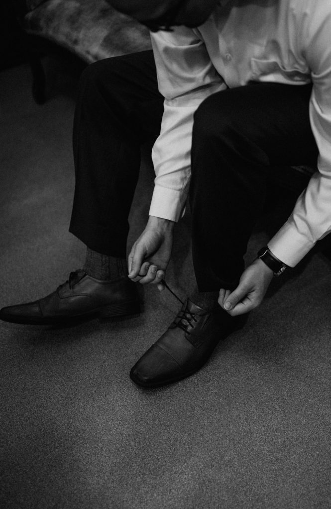 groom tying shoes