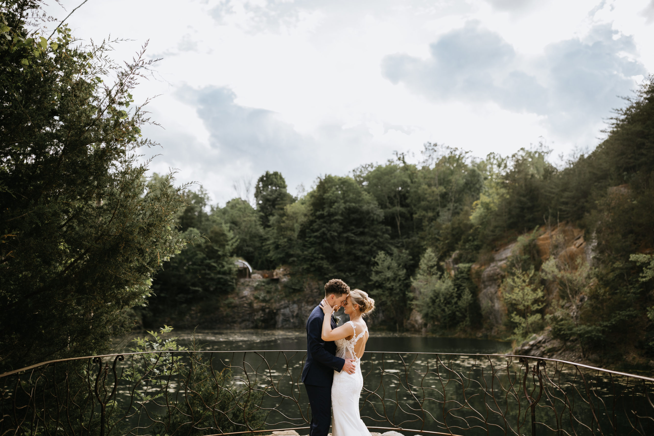 bride and groom kissing in front of lake at waterstone johnson city tennessee