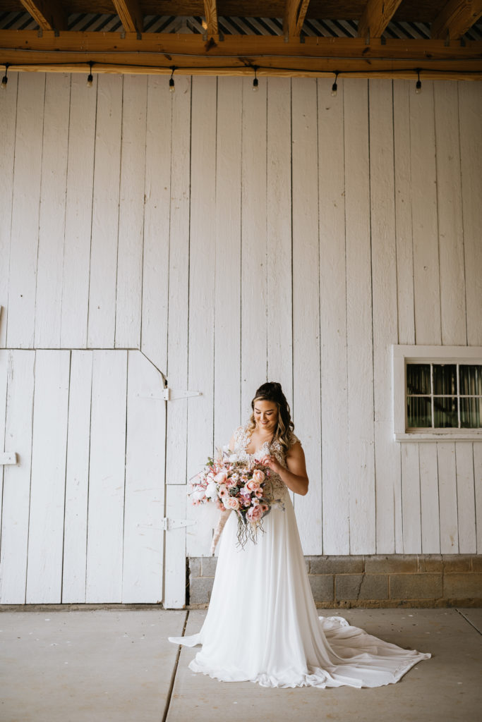 solo bride looking at bouquet