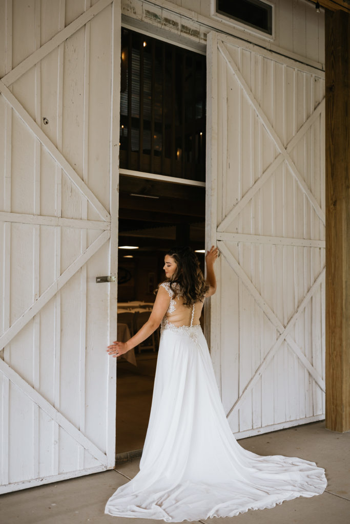 bride between doors at venue