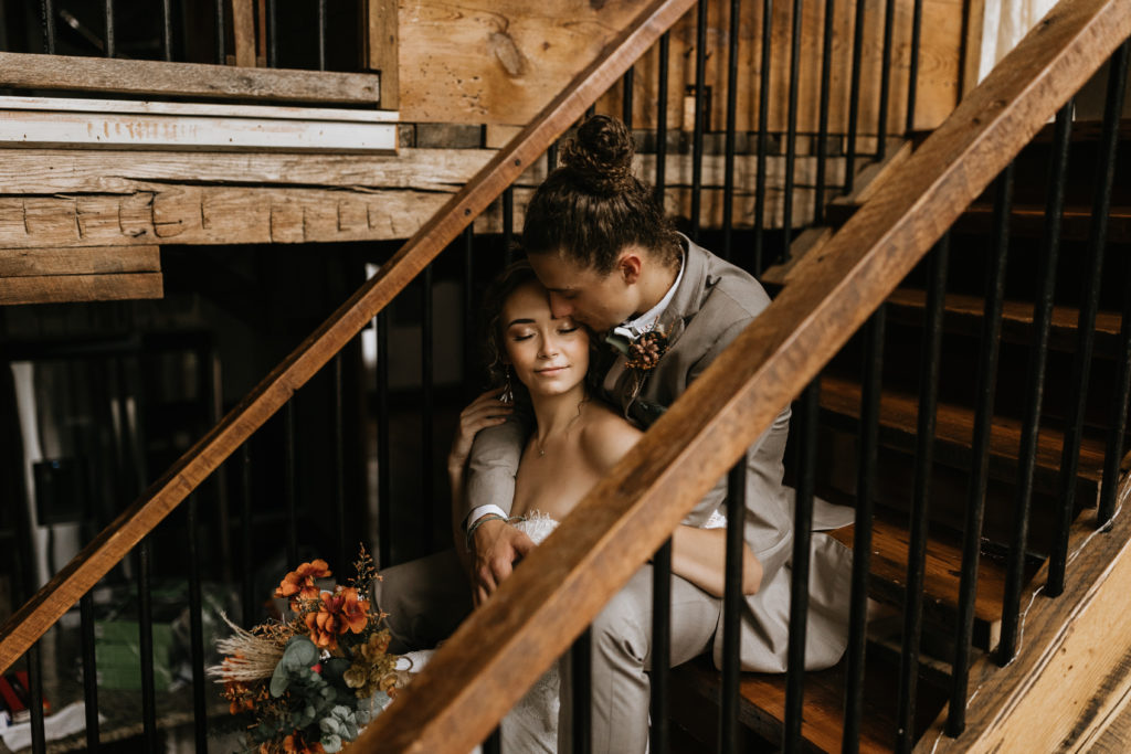 The Millstone Bride and groom sitting on stairs