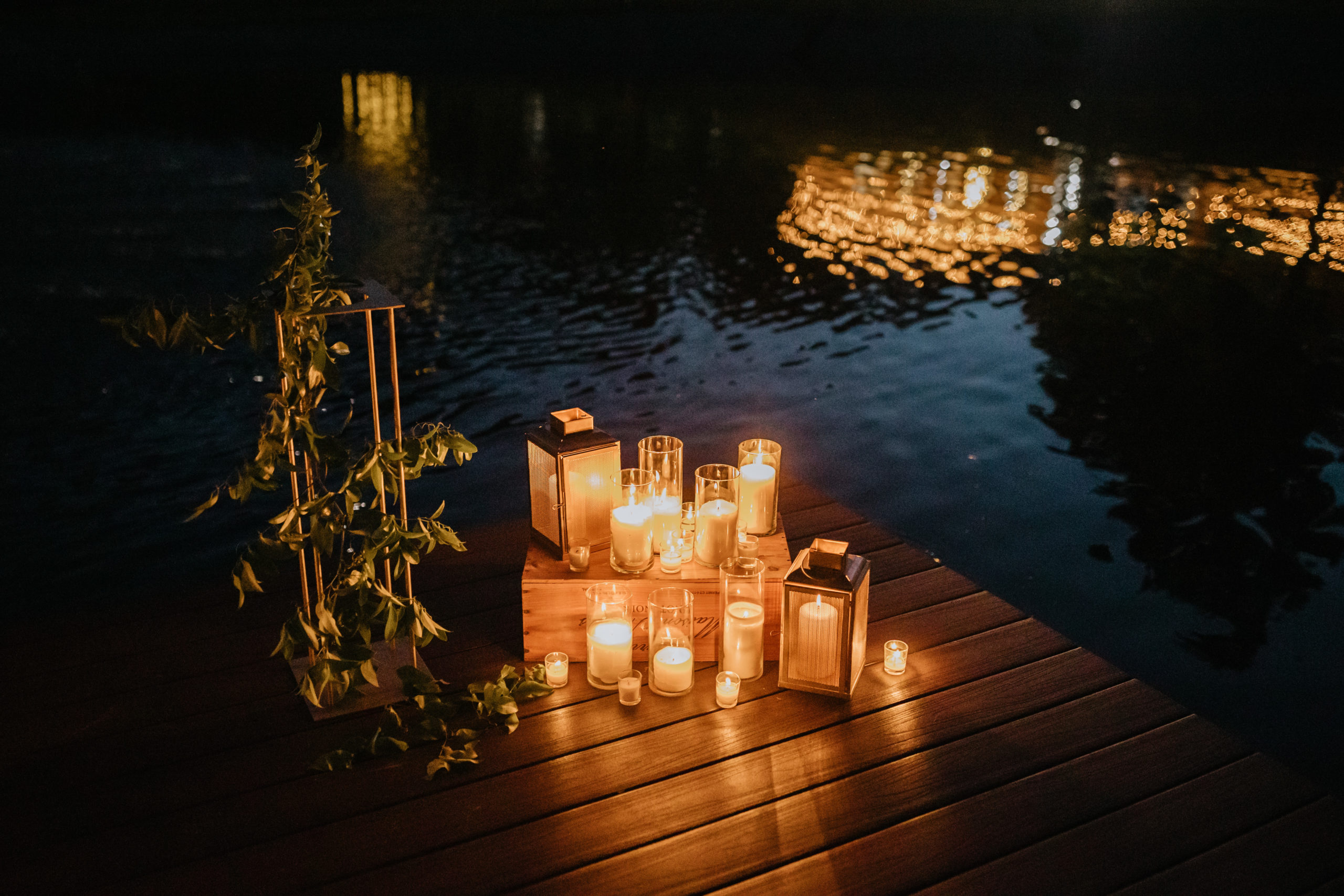 candles on a pier as a wedding venue reflects on the water
