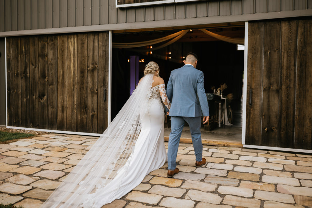 Bride and groom walking back into reception space