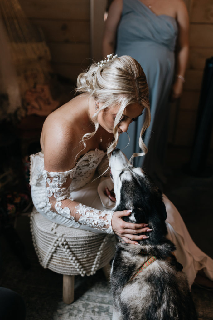bride petting dog Sadie as she gets ready